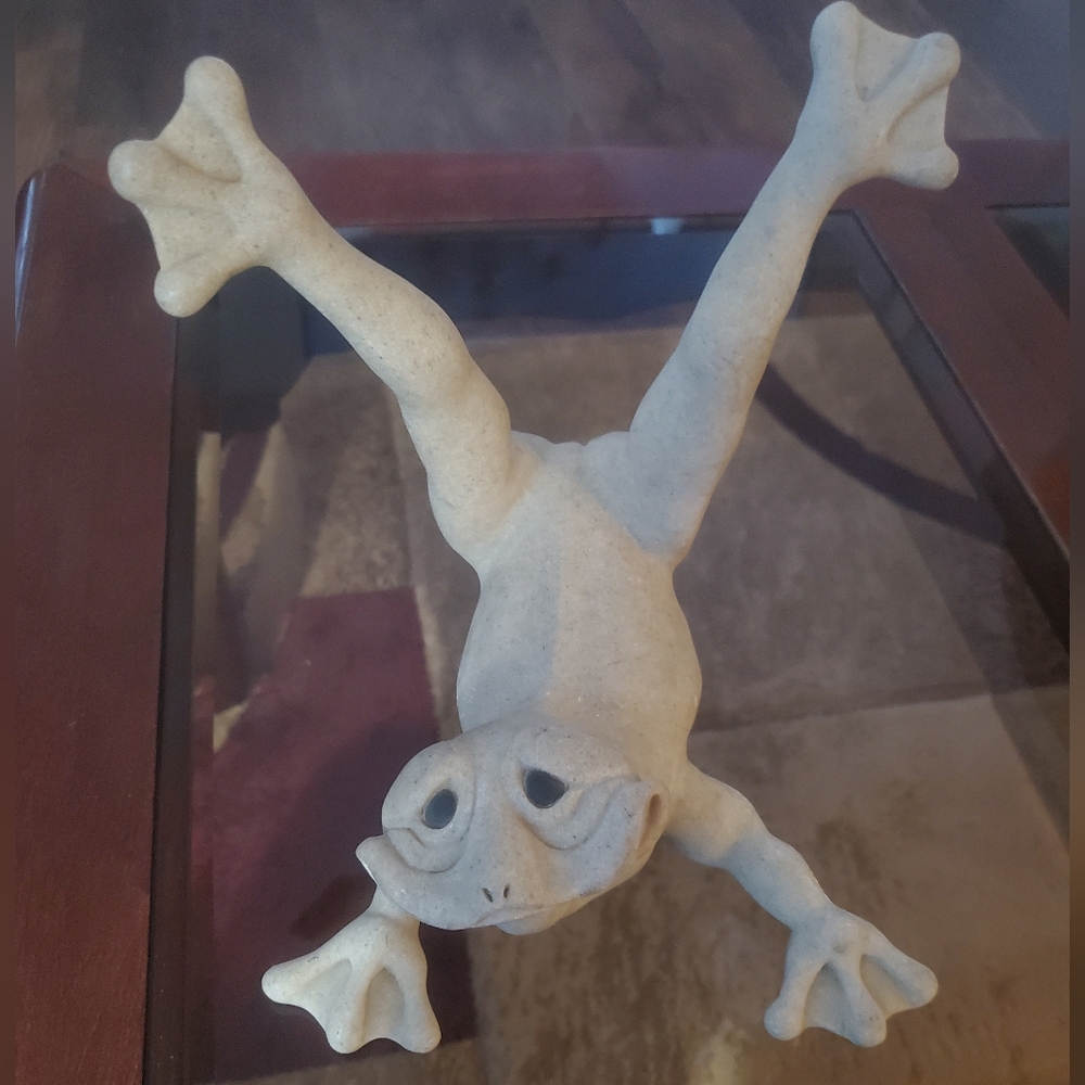 Faux stone looking cute goofy frog statute